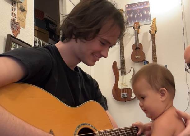 boyfriend and baby play guitar